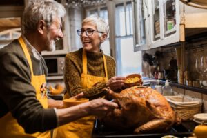 senior-couple-taking-turkey-from-oven