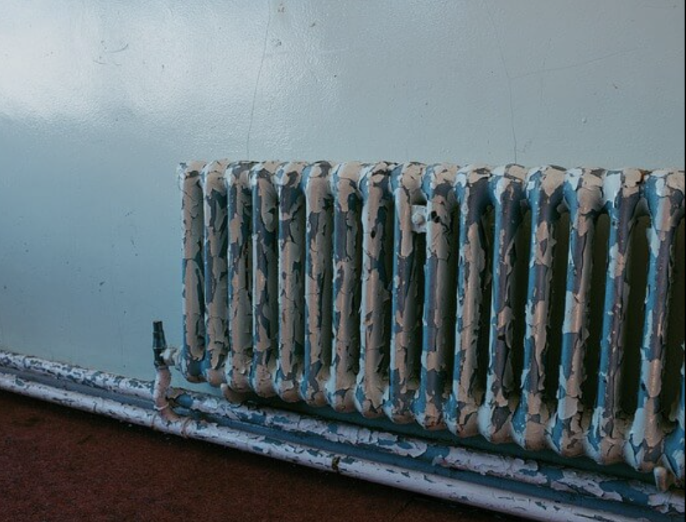 Rusty radiant heater in New England home