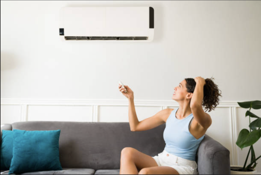 Woman Trying To Turn On Broken A/C System