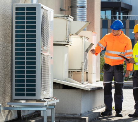 HVAC Technicians Inspecting Heat Pump System 