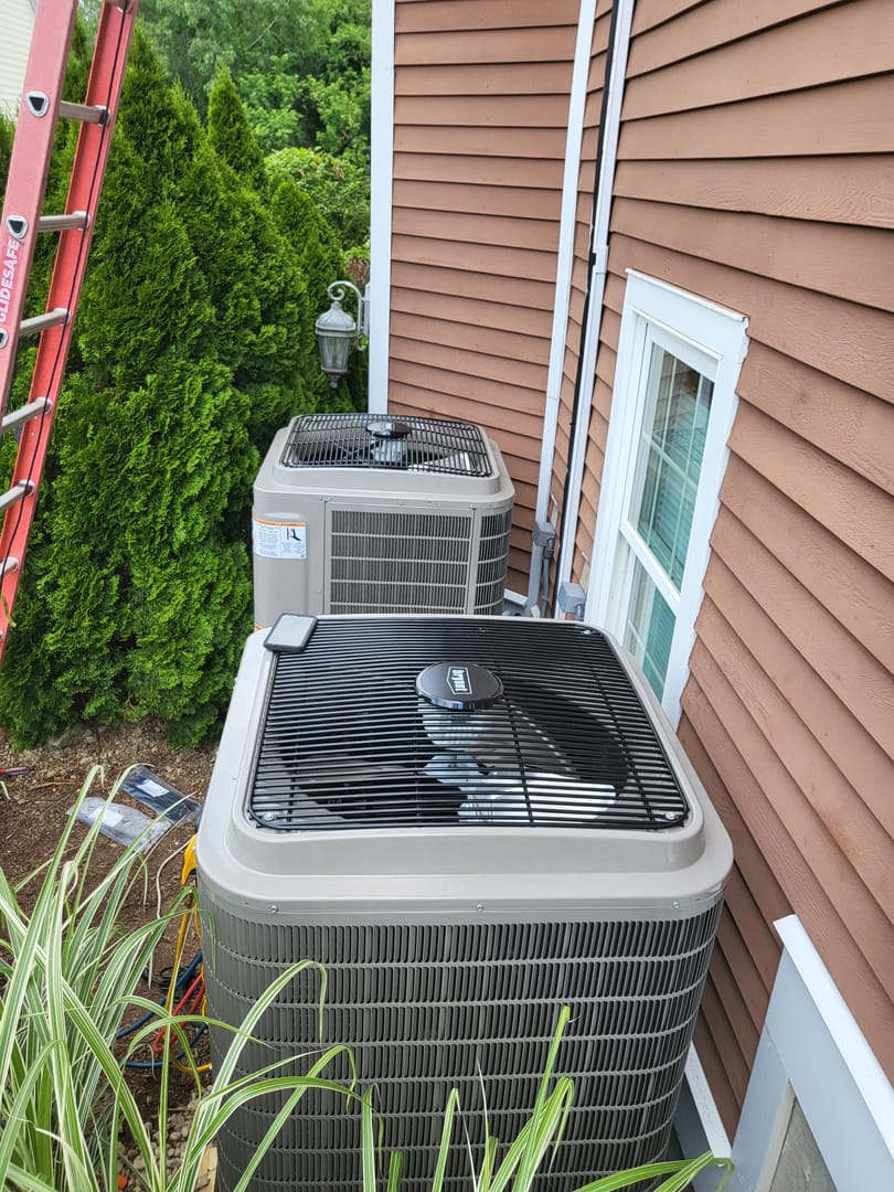 Two AC units outside being installed