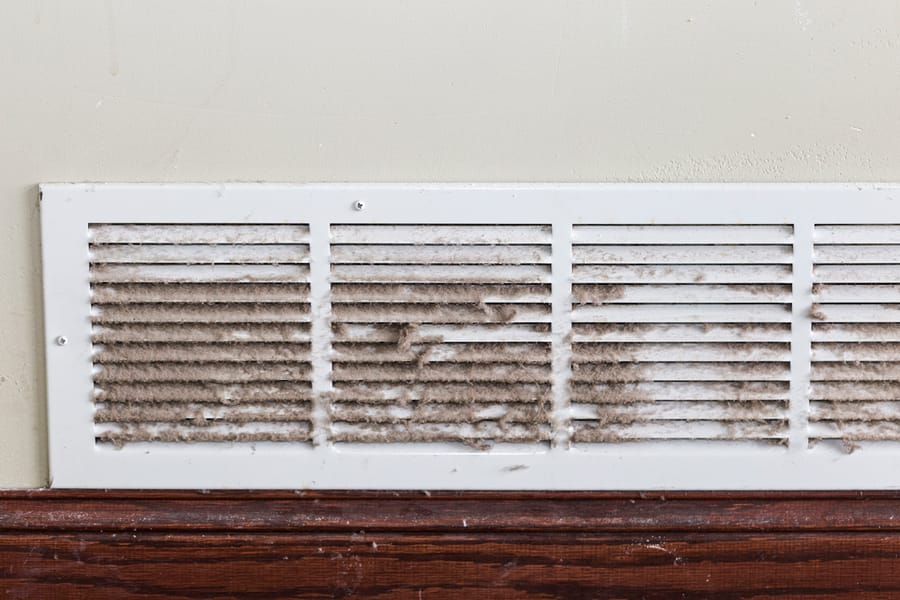 Dirty vent on lower wall showcasing the importance of a dehumidifier