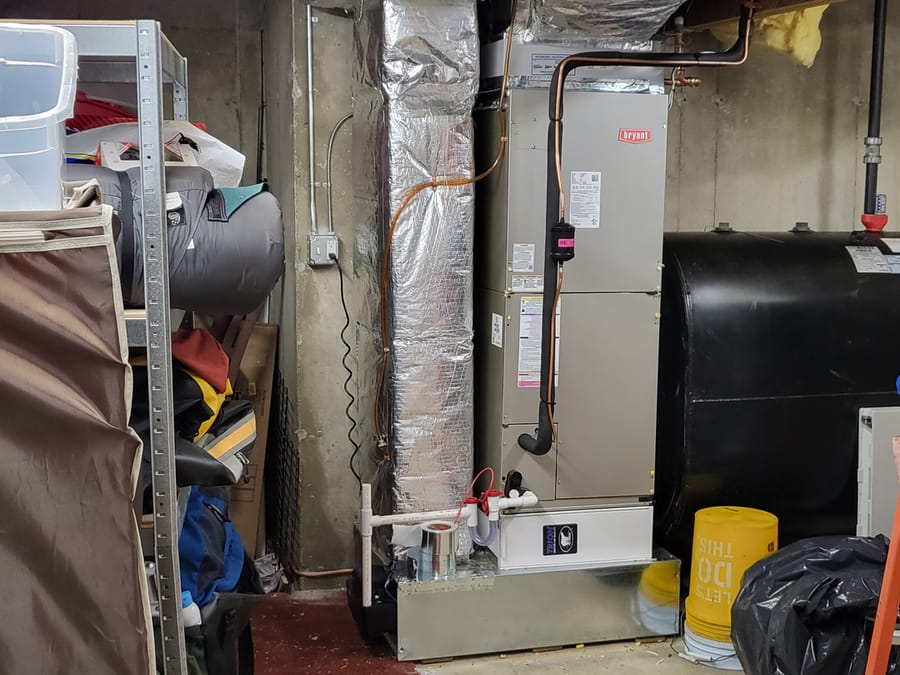 HVAC unit with associated ductwork and an oil tank.