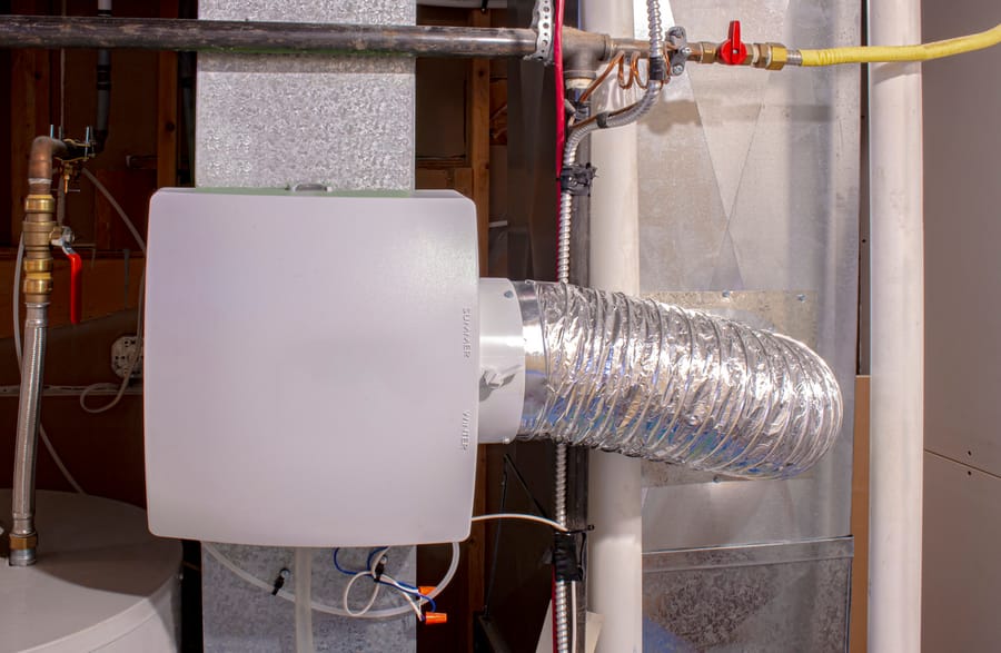 Whole-home humidifier attached to the return duct with a bypass connection to the supply hot air duct.