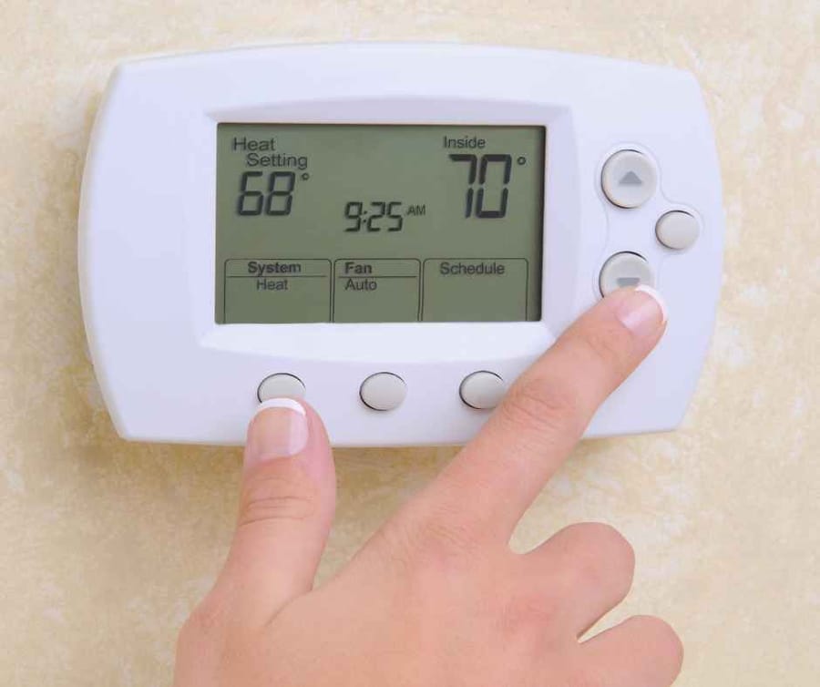 Adjusting a thermostat to lower the temperature
